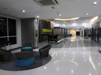 a lobby with couches and chairs in a building at manila sea view homes 21 in Manila
