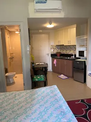 a kitchen with a table and a counter top at Favila Condotel Unit-150 Newport Boulevard near Airport Terminal 3 and all other Airport in Manila