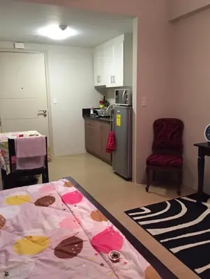 a room with a kitchen with a bed and a table at Favila Condotel Unit-150 Newport Boulevard near Airport Terminal 3 and all other Airport in Manila