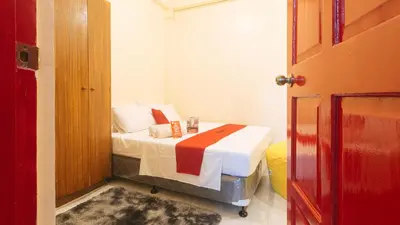 a bedroom with a bed in a room with a door at RedDoorz at VCloud Hills near De La Salle Dasmarinas Cavite in Dasmariñas
