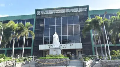 a building with a statue in front of it at RedDoorz at VCloud Hills near De La Salle Dasmarinas Cavite in Dasmariñas