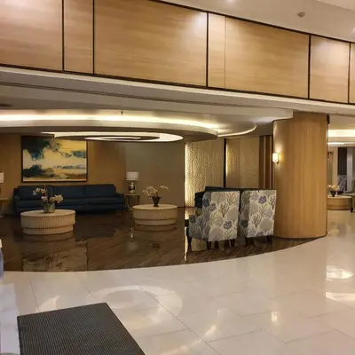 a lobby with two chairs and a couch at SHELL RESIDENCES in Manila