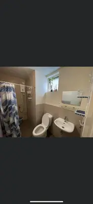a bathroom with a toilet and a sink at Khentdrick's Place at Holland Park Southwoods in Biñan