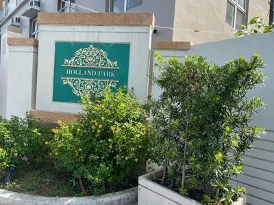 a sign for a hotel and park with orange trees at Khentdrick's Place at Holland Park Southwoods in Biñan