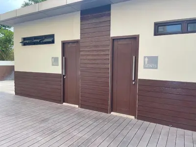 two brown doors on the side of a building at Khentdrick's Place at Holland Park Southwoods in Biñan