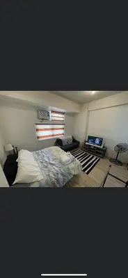 a small bedroom with a bed and a window at Khentdrick's Place at Holland Park Southwoods in Biñan