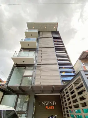 a tall building with windows on top of it at UNWND Flats in Manila
