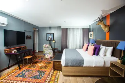 a hotel room with a bed and a desk at UNWND Flats in Manila