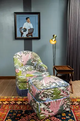 a living room with a chair and a ottoman at UNWND Flats in Manila