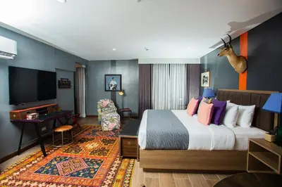 a hotel room with a large bed and a desk at UNWND Flats in Manila