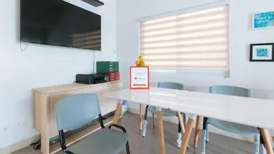 a dining room with a white table and chairs at RedDoorz Plus at Alpina Heights Paranaque in Manila