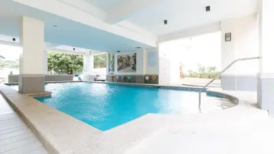 a swimming pool in the middle of a house at RedDoorz Plus at Alpina Heights Paranaque in Manila