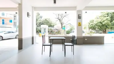 a table and two chairs in an empty building at RedDoorz Plus at Alpina Heights Paranaque in Manila