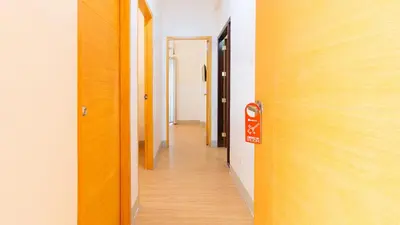 a corridor of an office with a door and a hallway at RedDoorz Plus at Alpina Heights Paranaque in Manila