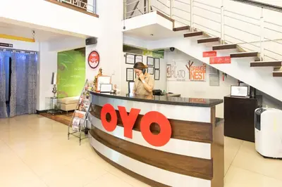 a woman standing at a counter in a store at Orange Nest Hotel in Manila