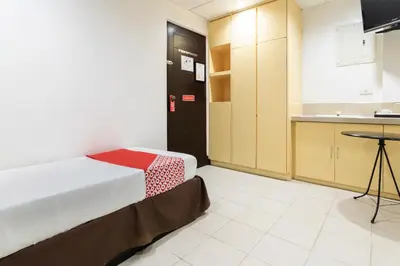a small room with a bed and a kitchen at Orange Nest Hotel in Manila