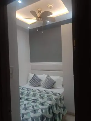a bedroom with a bed with a ceiling fan at Fame Residences T1 Family Suite 1507 in Manila