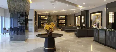 a lobby with a table with flowers on it at Fame Residences T1 Family Suite 1507 in Manila