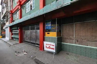 a building with a sign on the side of it at RedDoorz near Pasay Rotonda in Manila