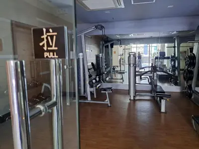 a gym with treadmills and machines in a room at NAIA Terminal 3 Condotel by Ann in Manila