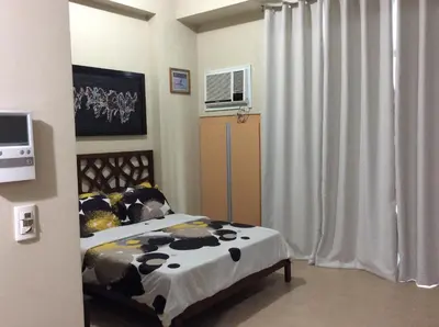 a bedroom with a bed with a cow blanket at NAIA Terminal 3 Condotel by Ann in Manila