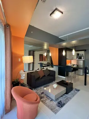 a living room with a couch and a table at KL Serviced Residences Managed by HII in Manila