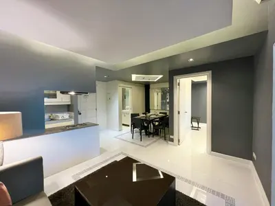 a kitchen and dining room with a table in a room at KL Serviced Residences Managed by HII in Manila