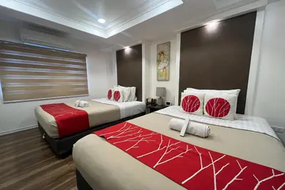 a hotel room with two beds with red and white at Khotel near T3 Airport in Manila