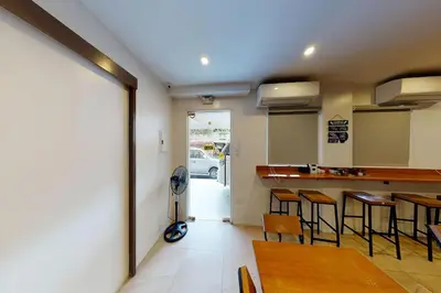 a room with a kitchen with a table and chairs at Khotel near T3 Airport in Manila