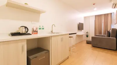a kitchen with a sink and a counter in a room at RedDoorz Plus at La Belle Residences Makati City in Manila