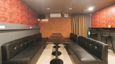 a waiting room with black leather seats and a table at RedDoorz Plus at La Belle Residences Makati City in Manila