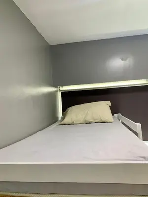 a white bed in a small room at Anuva Condominium with Netflix in Manila