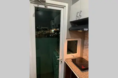 a door to a bathroom with a view of a city at Anuva Condominium with Netflix in Manila