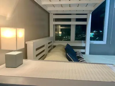 a bedroom with a bed and a window with a view at Anuva Condominium with Netflix in Manila