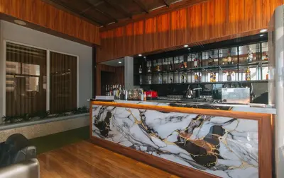 a bar with a marble counter in a room at RedDoorz Plus at Canley Residential in Manila