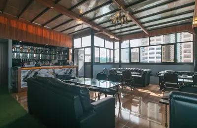 a restaurant with leather chairs and tables and windows at RedDoorz Plus at Canley Residential in Manila