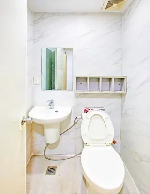 a bathroom with a toilet and a sink at Collection O Metro Manila near University Belt formerly 1318 Residences in Manila