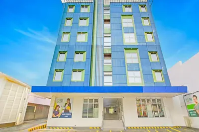 a tall blue building with a blue roof at Collection O Metro Manila near University Belt formerly 1318 Residences in Manila