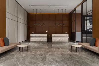 a lobby with two tables and two stools at Sheraton Manila Bay in Manila
