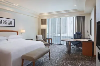 a hotel room with a bed and a desk at Sheraton Manila Bay in Manila