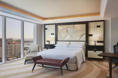 a bedroom with a king sized bed and a desk at Sheraton Manila Bay in Manila