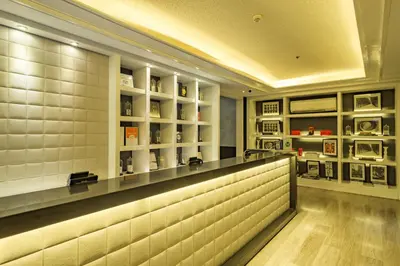 a bar in a restaurant with white tiles at Azumi Boutique Hotel in Manila