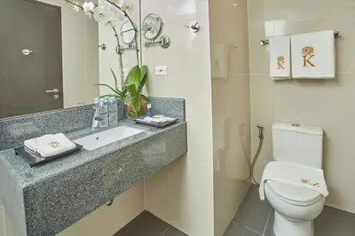 a bathroom with a sink and a toilet at Kingsford Hotel Manila Bay in Manila