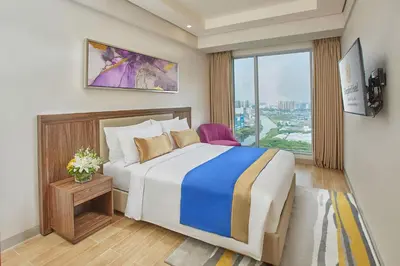 a bedroom with a large bed and a window at Kingsford Hotel Manila Bay in Manila