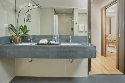 a bathroom with a sink and a mirror at Kingsford Hotel Manila Bay in Manila