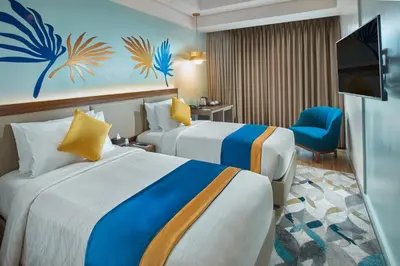a hotel room with two beds and a television at Kingsford Hotel Manila Bay in Manila