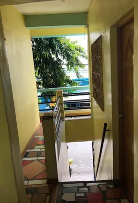a view from the hallway of a house with a window at Belen Favila Transient rooms near Airport Terminal 3 in Manila