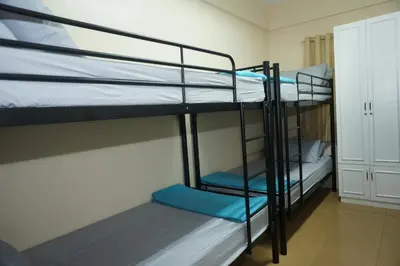 a room with two bunk beds in a room at Mint Homes in CEV Mansion in Manila