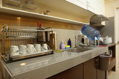 a kitchen with a sink and a counter top at Mint Homes in CEV Mansion in Manila