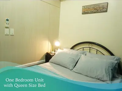 a bedroom with a bed with aone bedroom unit with queen size bed at Mint Homes in Jazz Residences Tower B in Manila